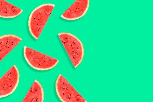 Flat lay of watermelon half slices on mint background. Watermelon pattern. Summer fruit. Creative Minimal summer pop art concept. Copy space