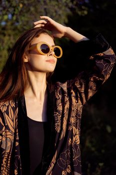 pretty woman wearing sunglasses outdoors fashion nature. High quality photo