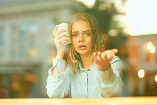 Business woman in a cafe in the summer outdoors on vacation. High quality photo