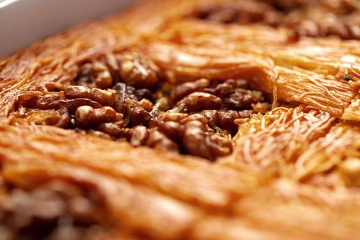 Close up photo of Turkish Baklava dessert with honey and nuts