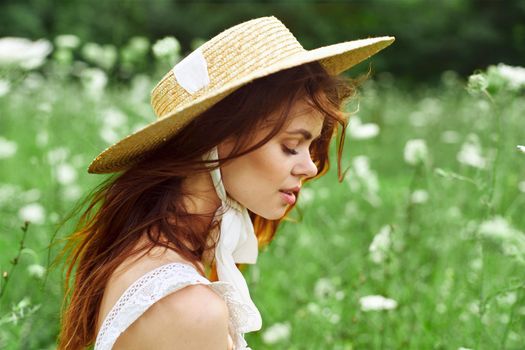 pretty woman with hat nature field flowers fresh air. High quality photo