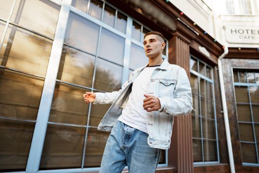 Portrait of handsome young casual man walking on the city street