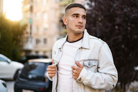 Portrait of handsome young casual man walking on the city street