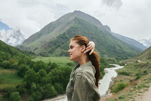 woman outdoors in the mountains landscape fresh air. High quality photo