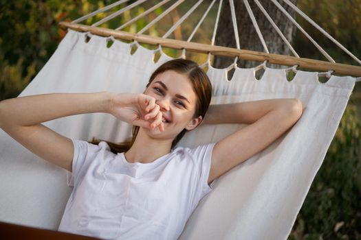 woman working on laptop in nature hammock freelance. High quality photo