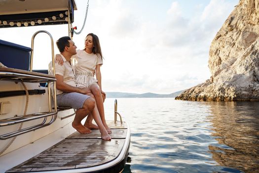 Loving couple spending time on a yacht at the open sea