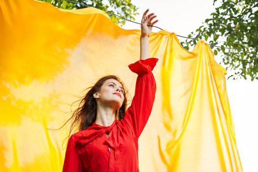 woman in red dress outdoors yellow bedspread. High quality photo