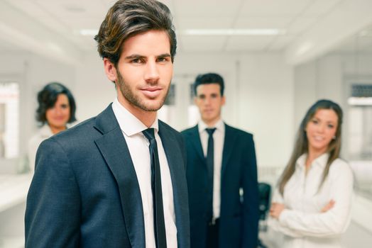 Image of business leader looking at camera in working environment