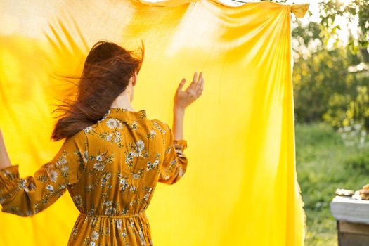 woman in dress posing nature yellow cloth fresh air. High quality photo