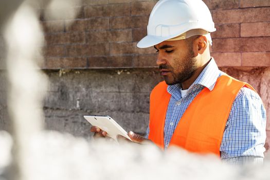 Portrait of young construction engineer wearing hardhat, close up