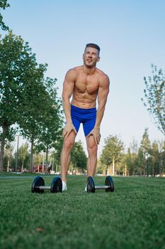 sporty man in park exercise crossfit workout. High quality photo