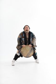 Funn caucasian bearded tattoed man is posing on white background