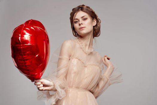 beautiful woman in a dress balloon Valentine's Day model studio. High quality photo
