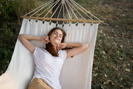 cheerful woman lies in a hammock outdoors nature vacation summer. High quality photo