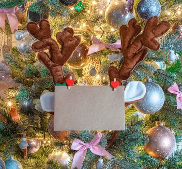 Christmas mail envelope with blank letter in decorated tree with reindeer ears for copy space close to, background, Holiday concept space for text