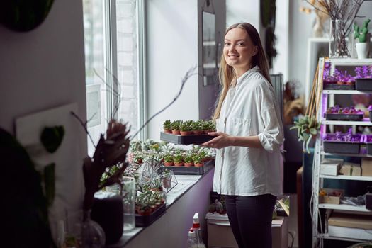 Portrait of caucasian female florist in its own florist shop