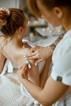 Confident female doctor is doing taping procedure in modenr treatment cabinet