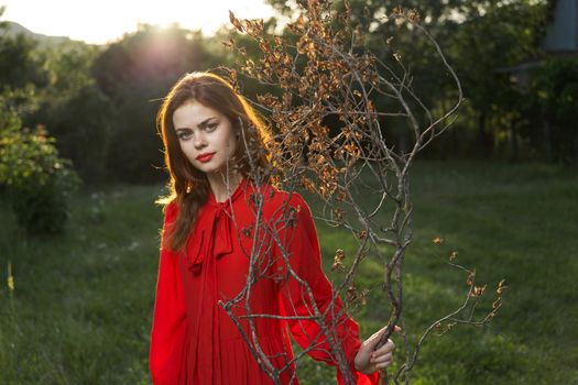 attractive woman in red dress outdoors fresh air summer. High quality photo