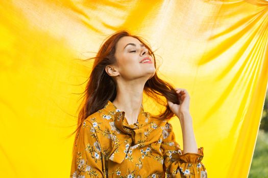 cheerful woman gesturing with her hands yellow background. High quality photo