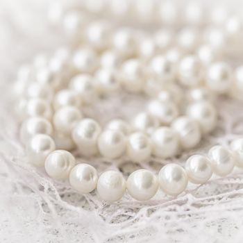 Nature white string of pearls in soft focus, with highlights.