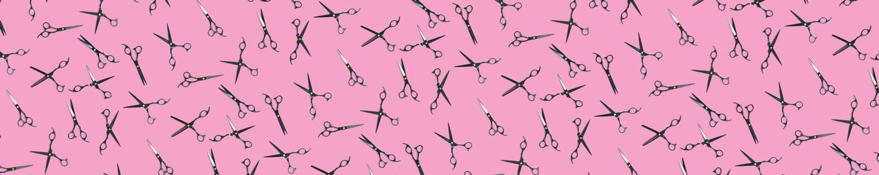 Background of black scissors. professional hairdresser black scissors isolated on pink. Black barber scissors, close up. pop art background, for prints or posters. not seamless pattern