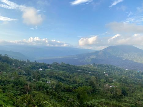 Hiking around the crater of Mount Batur with Mount Agung in the background