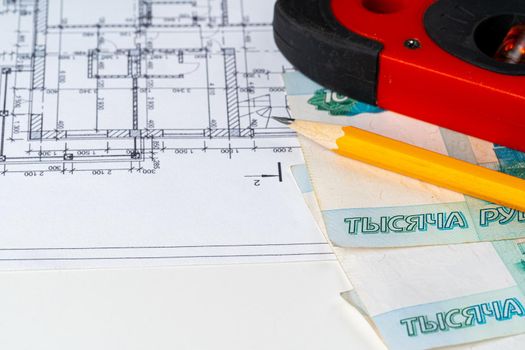 Architectural drawing and Russian Ruble money stack. High quality photo