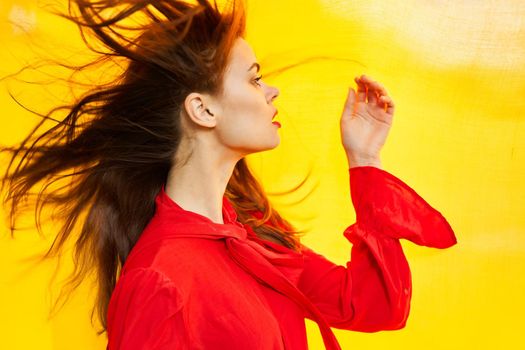 woman in red dress posing yellow fabric nature. High quality photo