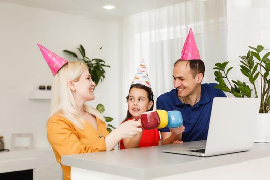 Happy family celebrating birthday via internet in quarantine time, self-isolation and family values, online birthday party