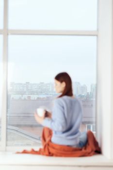 woman near the window dreamy look rest at home comfort. High quality photo