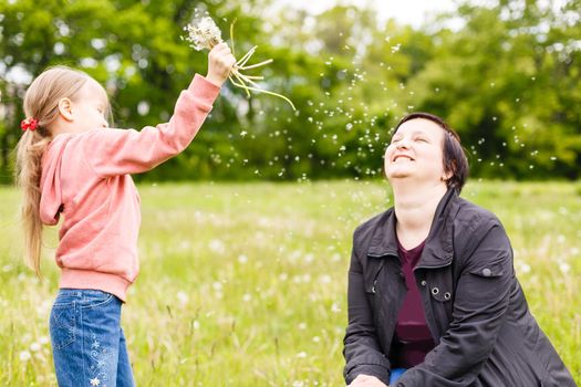 Cute little girl on the meadow in summer day