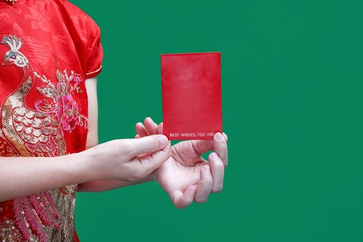 chinese woman holding new year red envelope or hong bao , text mean best whishes for you.