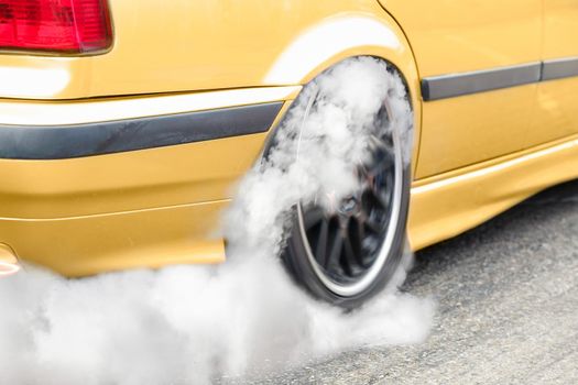 Drag racing car burns rubber off its tires in preparation for the race