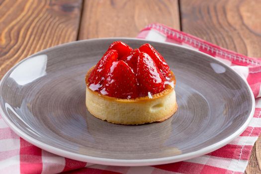 Mini tart with strawberries close up. Sweet berry dessert