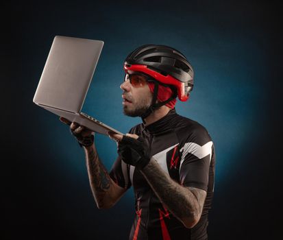 guy-cyclist in a Bicycle helmet with a laptop