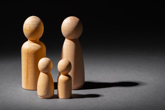Wooden little figures of people close up. Family concept