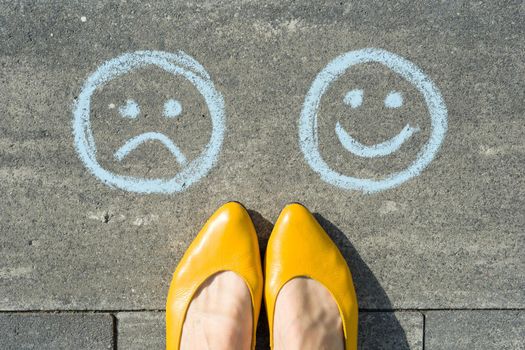 Choice - Happy Smileys or Unhappy, text on asphalt road.