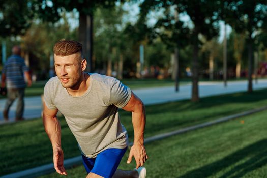 athletic man in the park workout jogging exercise summer. High quality photo