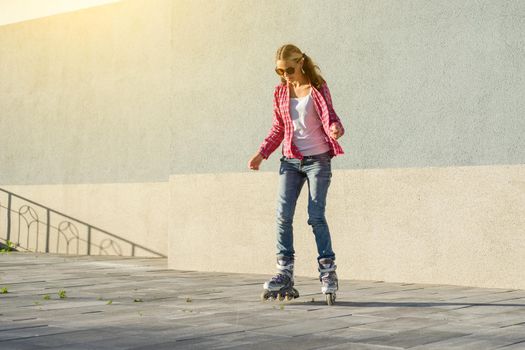 Active sports girl teen in roller skates on the urban background