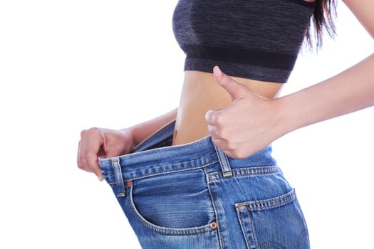 close up slim woman in old jeans showing thumbs up isolated on a white background