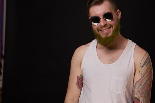 cheerful bearded man in white t-shirt sunglasses posing. High quality photo