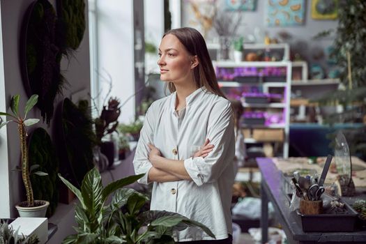 Portrait of caucasian female florist in its own florist shop