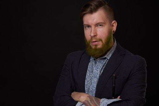 fashionable business man in a jacket with a beard posing. High quality photo