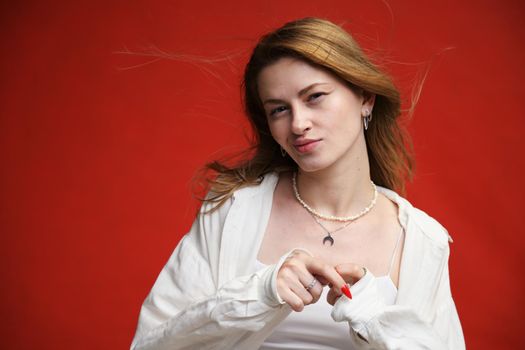 young european girl portrait on red background in studio