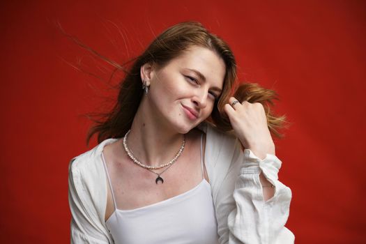 portrait of a satisfied young woman on a red background