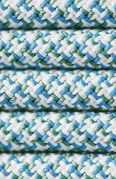 Close-up lines of climbing rope blue color, top view, texture.