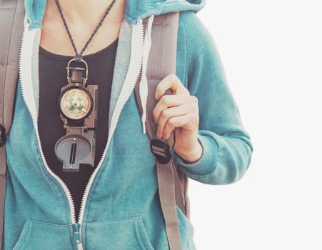 Unrecognizable traveler young woman with compass isolated on a white background. Free space in the right part of image.