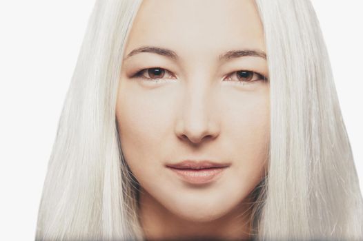 Portrait of a blonde mixed race young woman, looking at camera. Hairstyle.