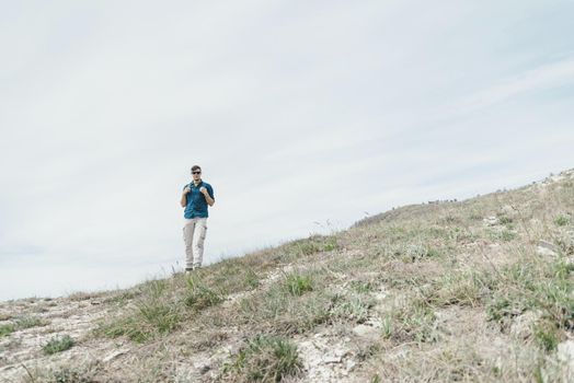 Explorer young man with backpack walking outdoor.