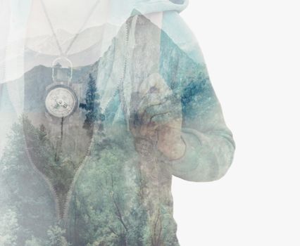 Double exposure image of female traveler with compass and pine tree forest.